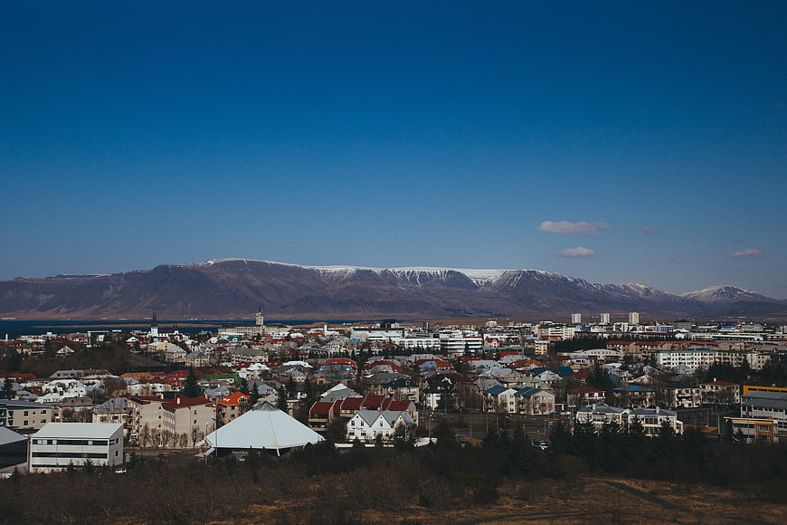 Wide cityscape view of Reykjavik with snow-capped mountains