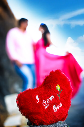 Red Heart Pillow with Couple in Background