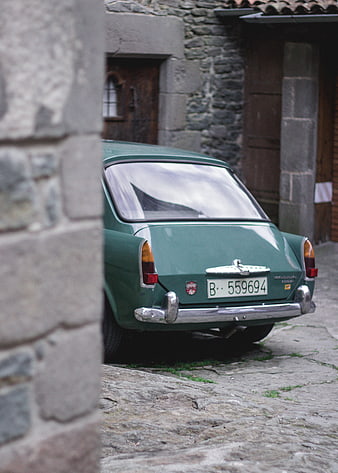 Vintage Green Volvo Amazon Parked in Cobblestone Street