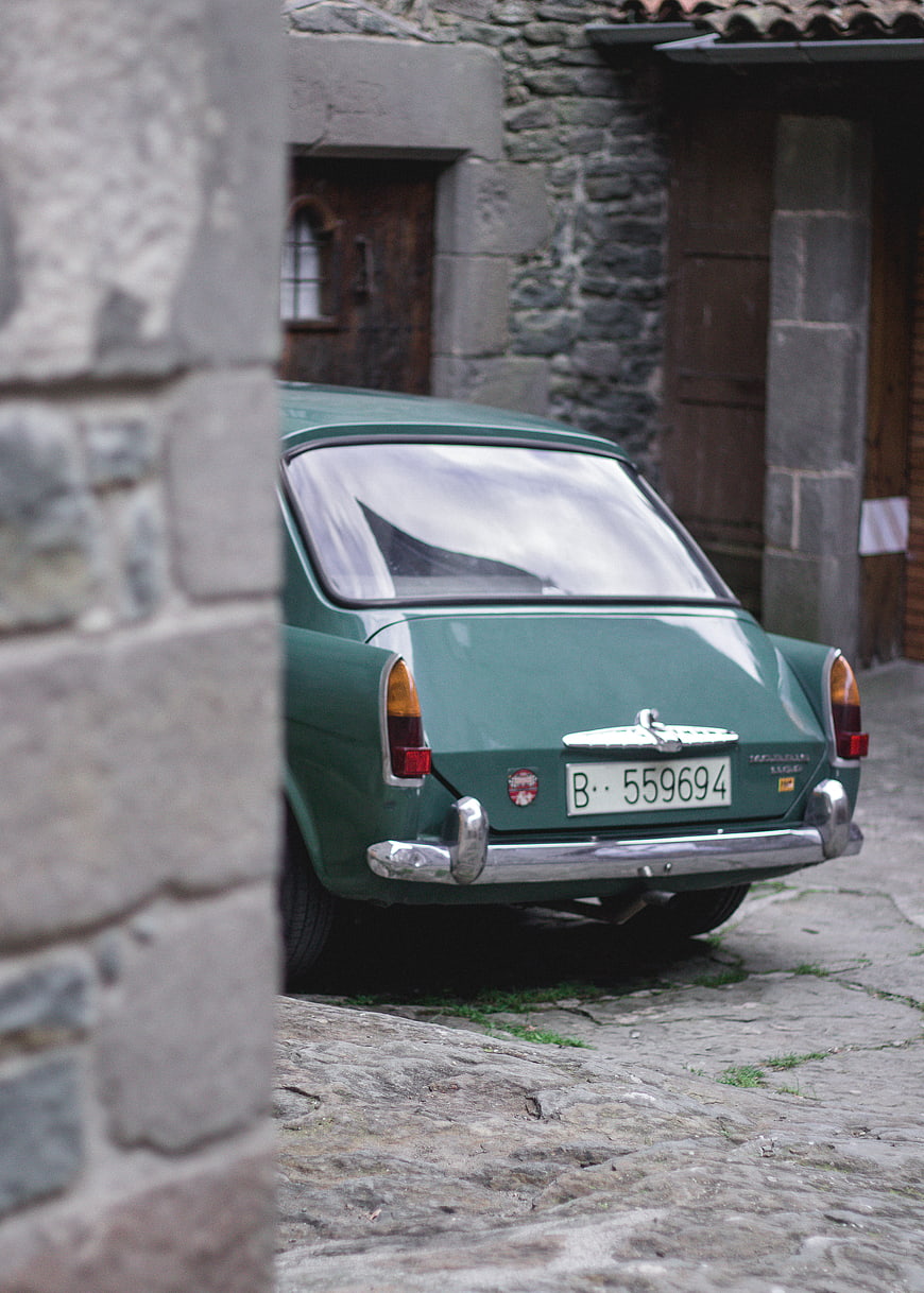 Vintage Green Volvo Amazon Parked in Cobblestone Street