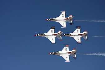 USAF Thunderbirds Diamond Formation Flight Against Blue Sky