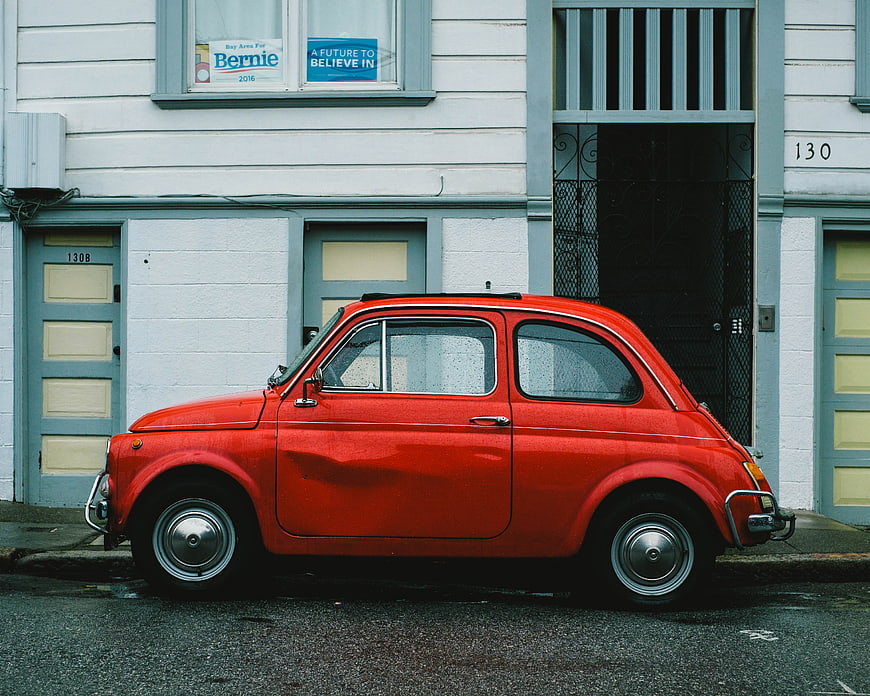 Vintage Red Fiat 500 Parked on Urban Street