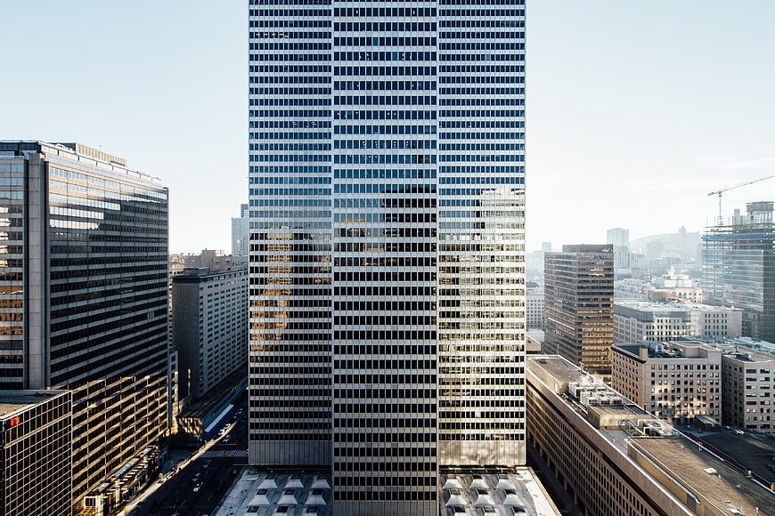 Tall modern skyscraper in urban cityscape with glass facade
