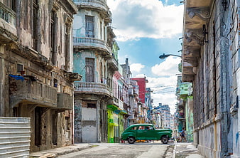 Vintage Green Car on Havana Street with Old Buildings