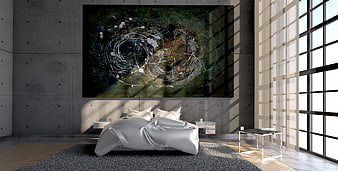 Modern industrial bedroom with large abstract art and sunlight