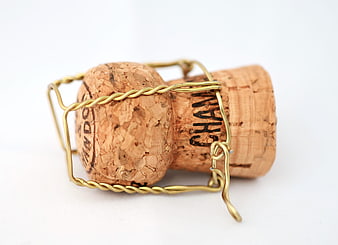 Champagne Cork with Gold Wire Cage on White Background
