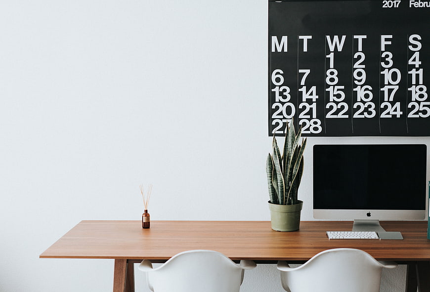 Minimalist Office Desk with Calendar and Plant