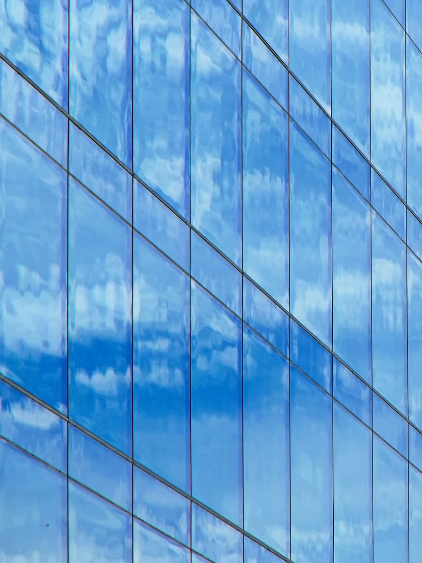 Blue Glass Building Facade with Sky Reflection