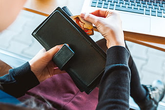 Woman holding credit card and wallet for online shopping
