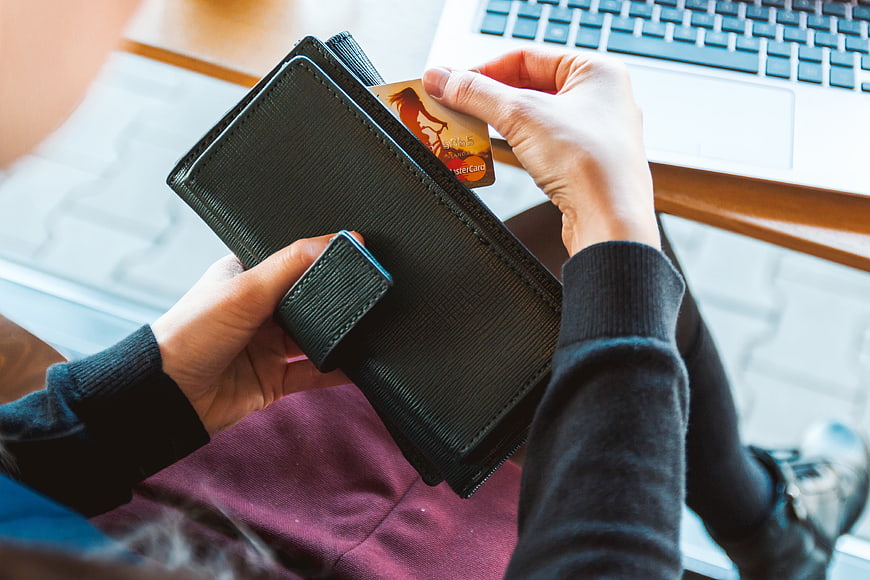Woman holding credit card and wallet for online shopping