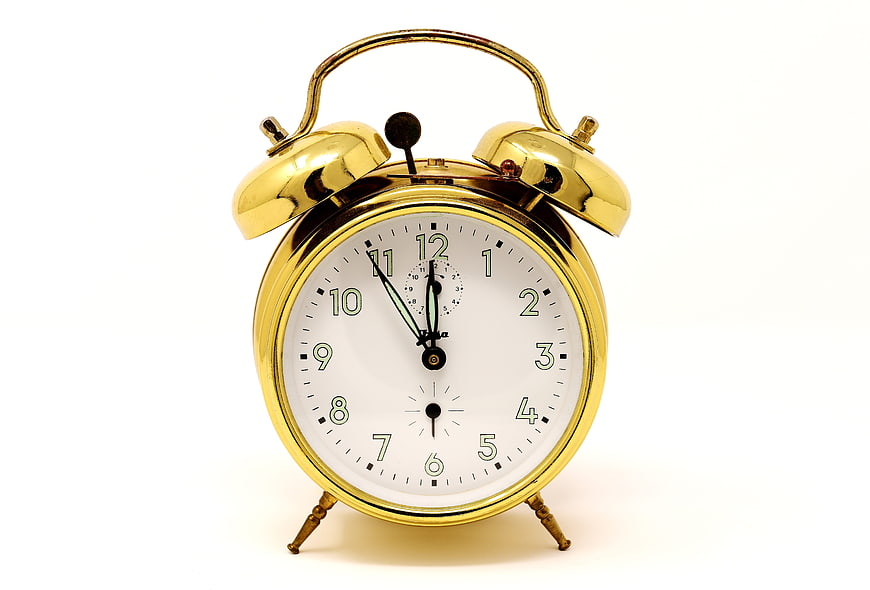 Gold Twin Bell Alarm Clock On White Background