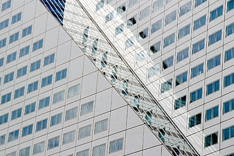 Modern white skyscraper facade with diagonal glass structure