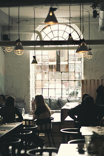 Vintage industrial cafe interior with arched window