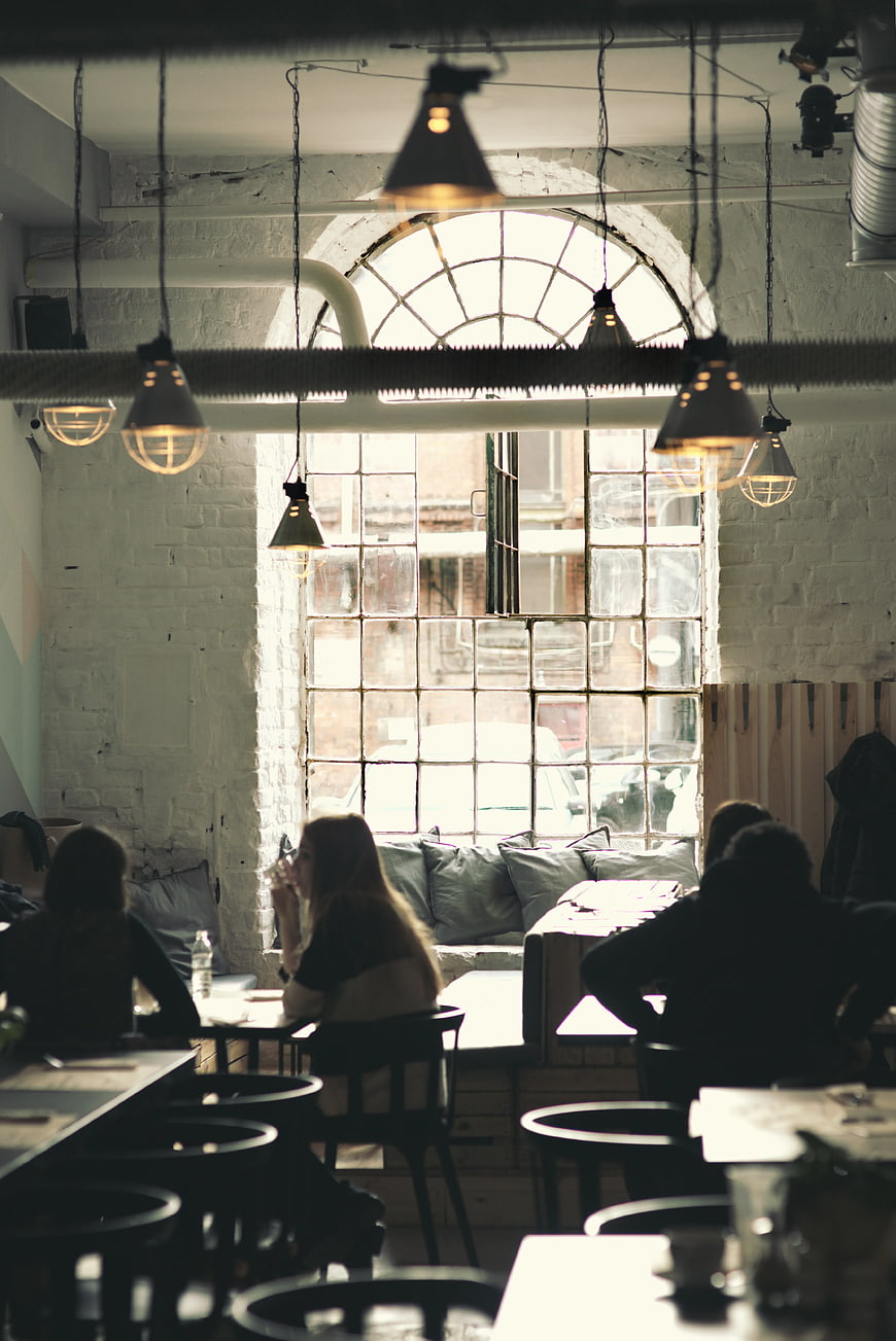 Vintage industrial cafe interior with arched window