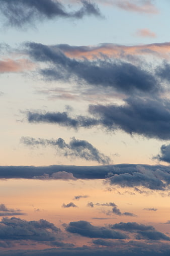 Dramatic sunset sky with layered clouds and pastel colors