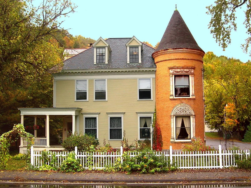Historic New England Victorian House With Brick Tower In Autumn