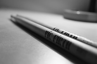 Close-up of wooden drumsticks on a textured surface
