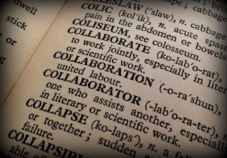Close-up of dictionary definition for collaboration and collaborator