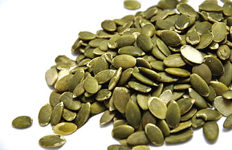 Pile of Green Pumpkin Seeds on White Background