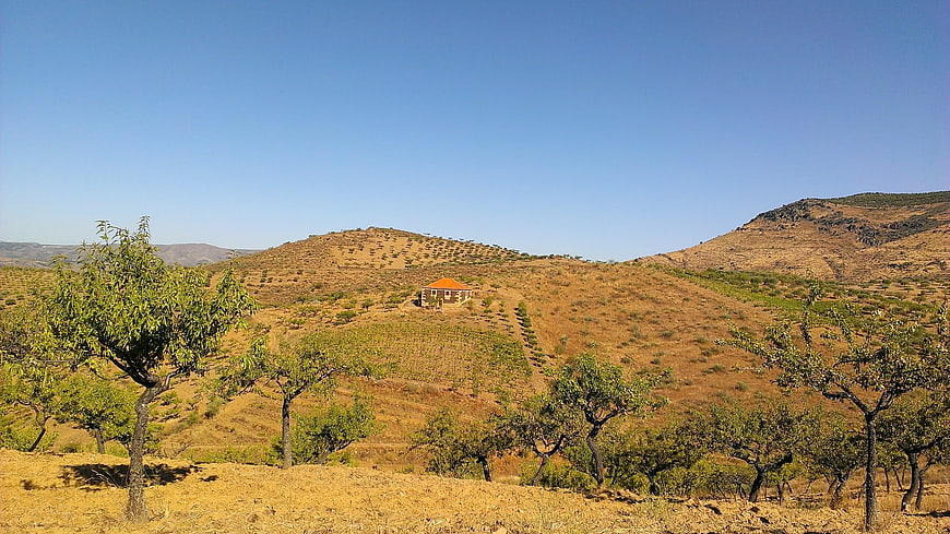 Rural landscape with small house on dry hillside