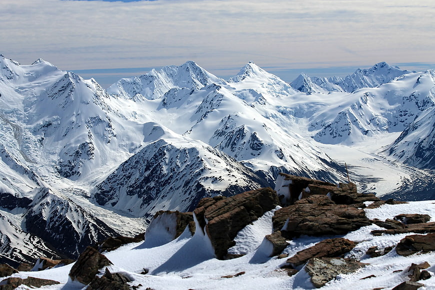 Snow-Covered Mountain Peaks with Rocky Foreground