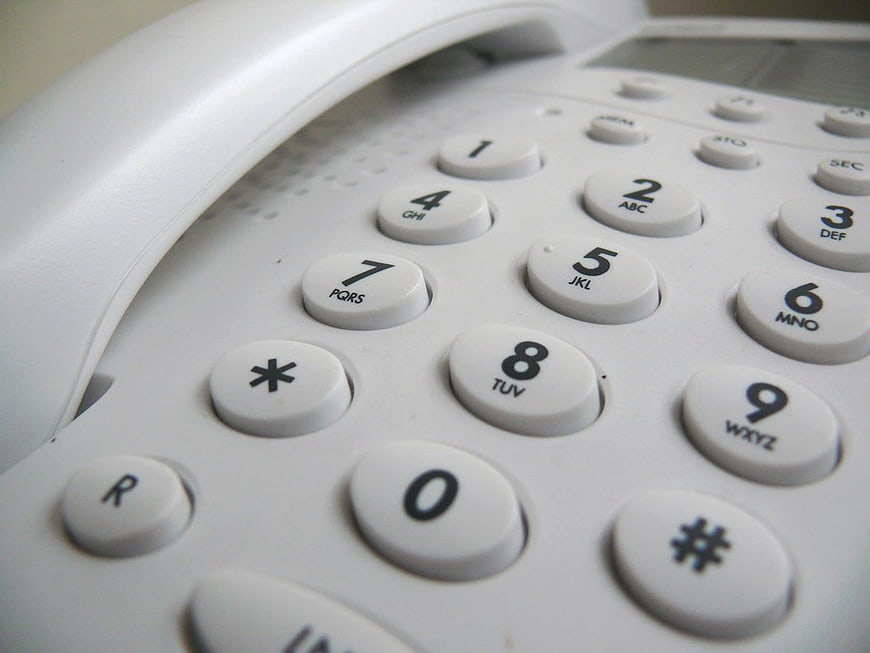 Close-up of white landline telephone keypad buttons