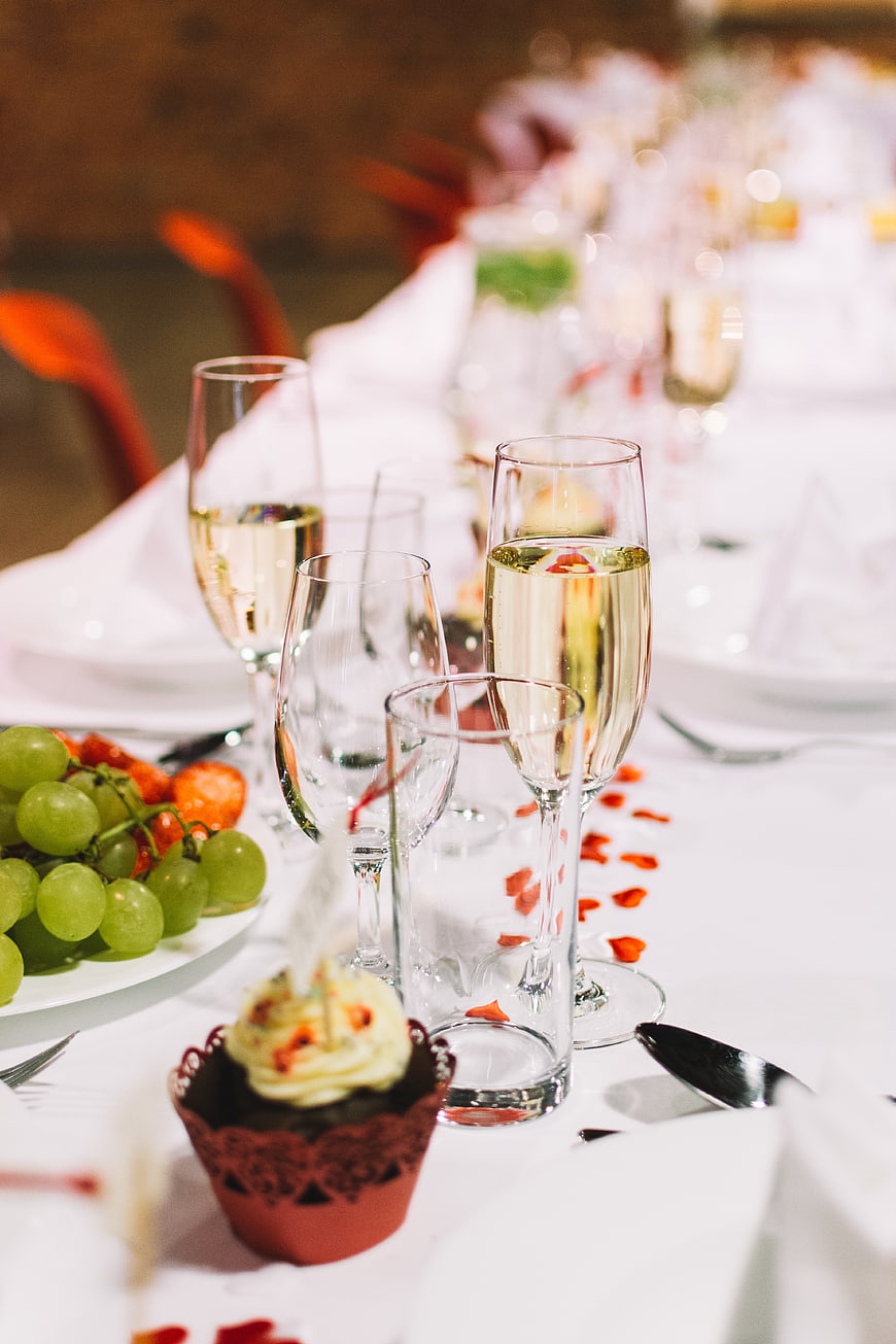 Champagne glasses and dessert on a wedding reception table