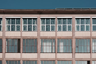 Modernist building facade with repeating window grid and numbers