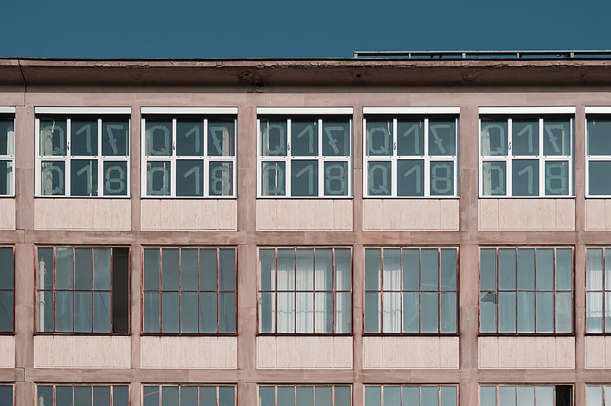 Modernist building facade with repeating window grid and numbers