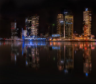 Rotterdam skyline at night with reflections in water