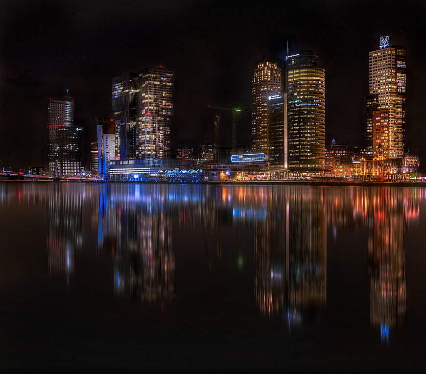 Rotterdam skyline at night with reflections in water
