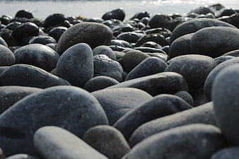 Close-up of smooth grey pebbles on a rocky beach
