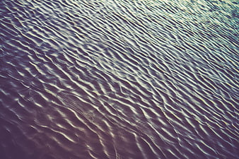Abstract purple and blue water ripples texture background