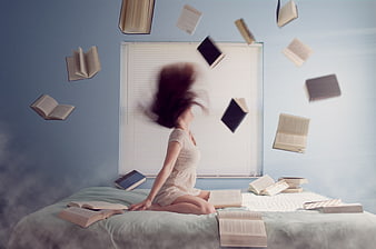 Woman with floating books in bedroom, motion blur, surreal reading concept