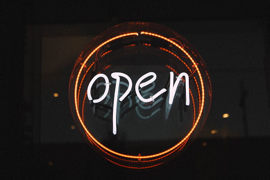 Glowing Round Neon Open Sign on Dark Background