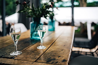 Two glasses of white wine on rustic wooden table