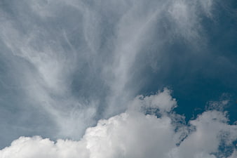 Dramatic wispy cirrus clouds against deep blue sky