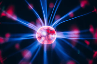 Abstract glowing red sphere with blue electric energy beams