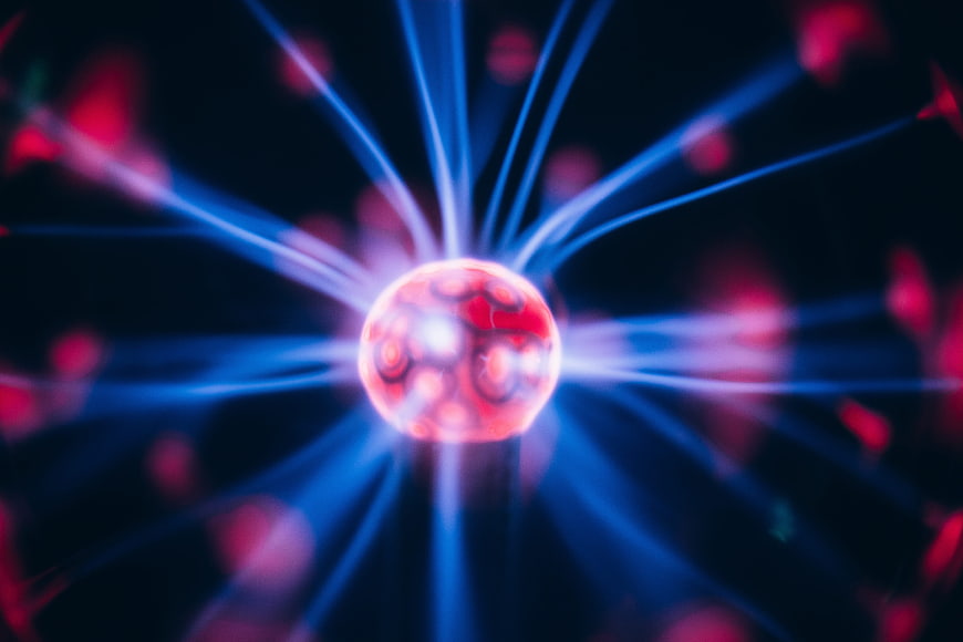 Abstract glowing red sphere with blue electric energy beams