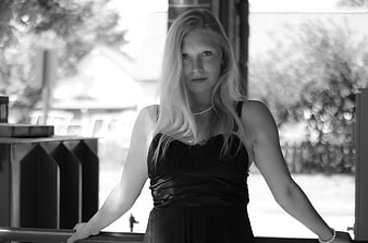 Black and white portrait of blonde woman in black dress
