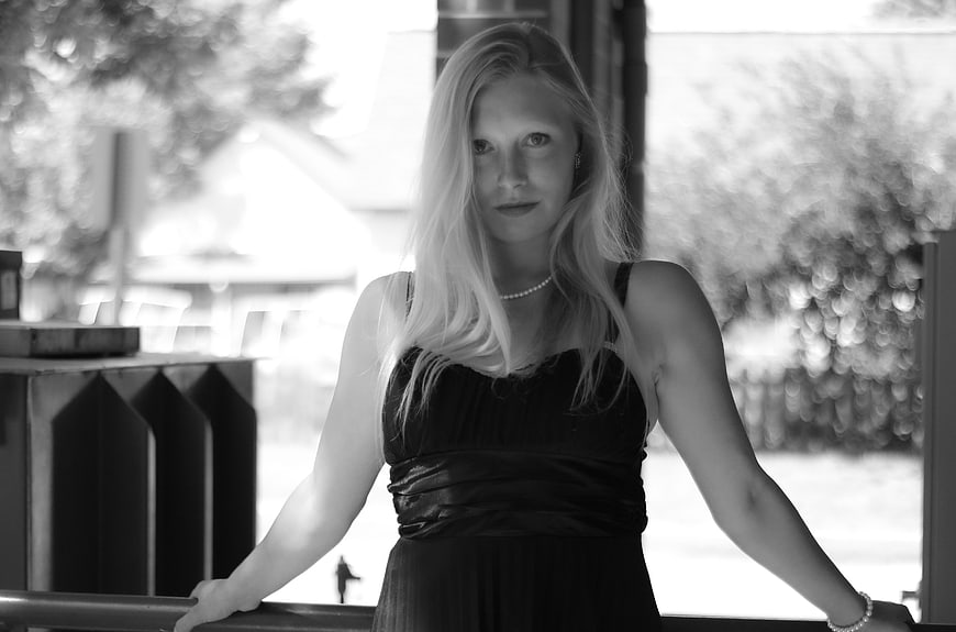 Black and white portrait of blonde woman in black dress
