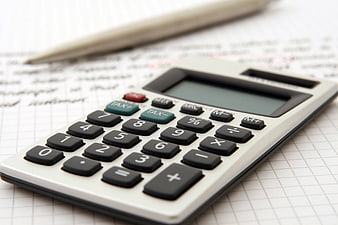 Calculator and pen on financial documents