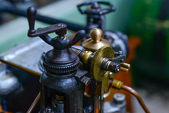 Close-up of vintage industrial machinery with brass gears