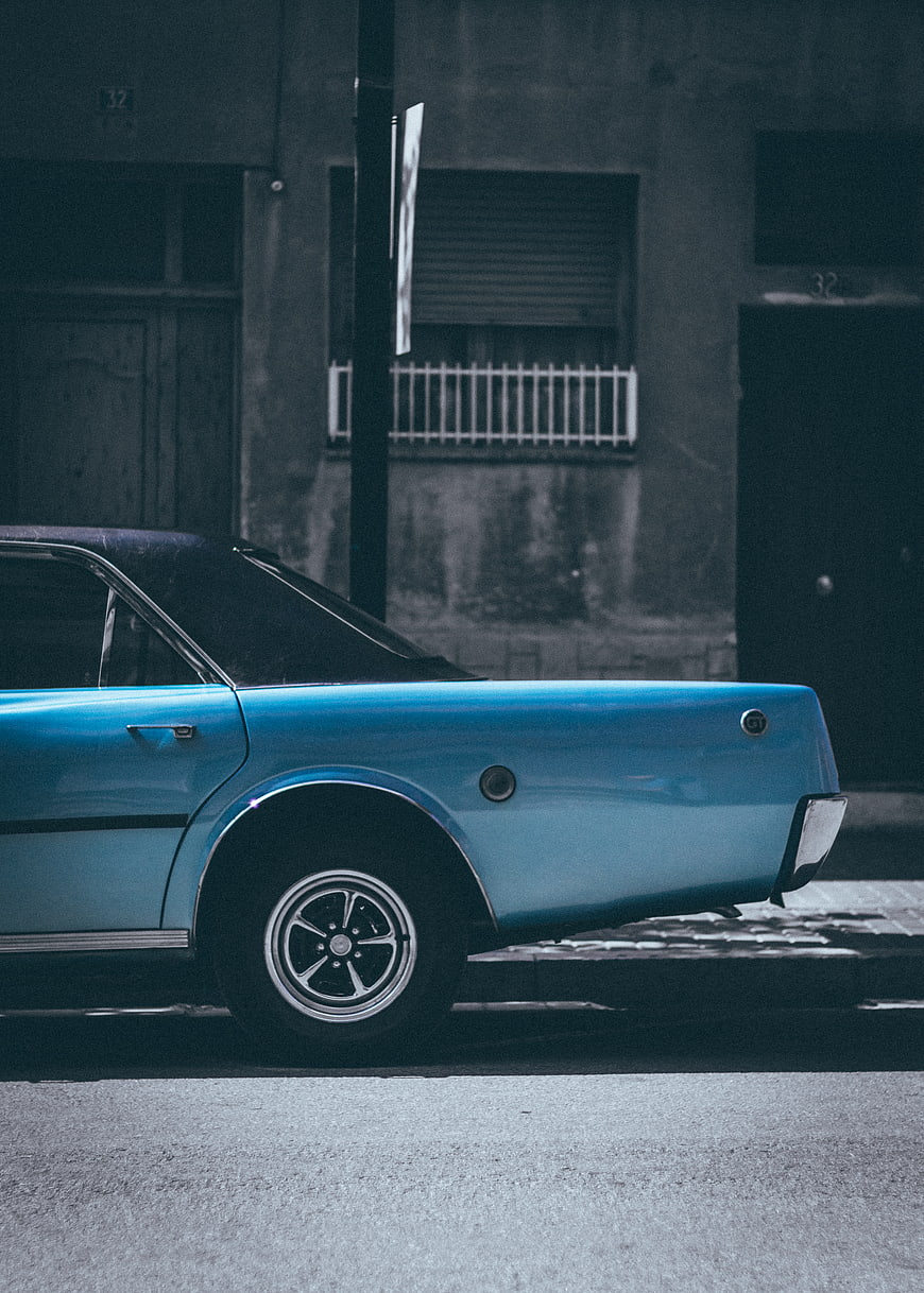 Rear view of vintage blue classic car parked on street