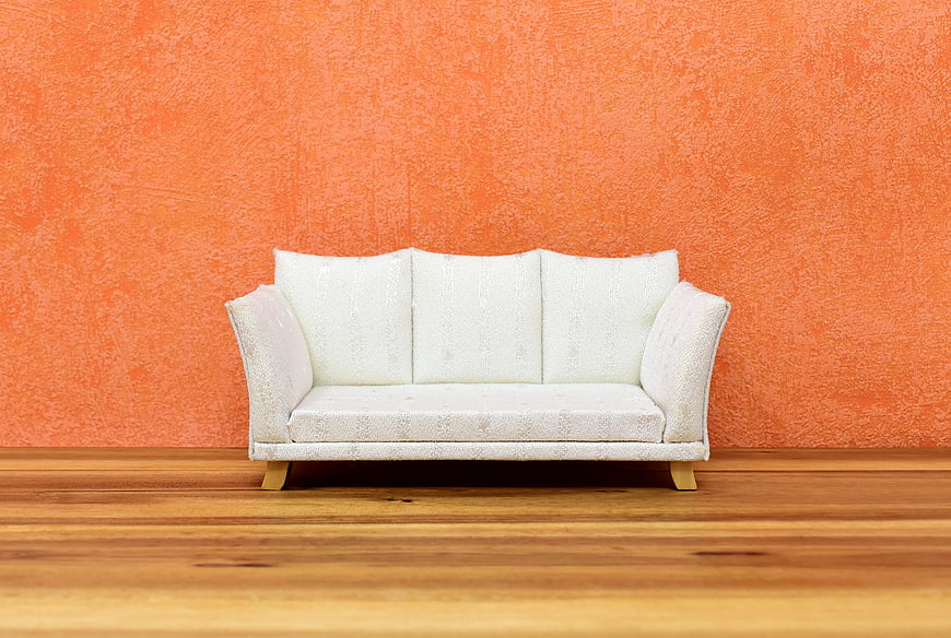 White Sofa Against Orange Wall