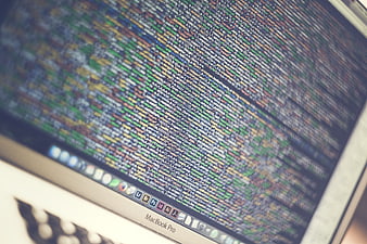 Close-up of MacBook Pro Screen Displaying Colorful Programming Code