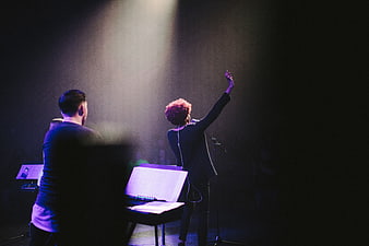 Singer Performing on Stage with Backlit Spotlight