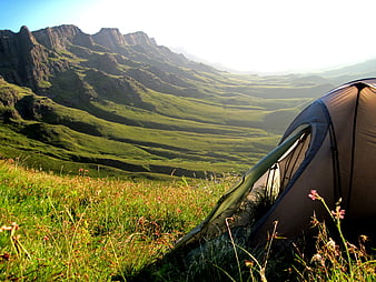 Camping Tent On Grassy Mountain Ridge With Distant Peaks