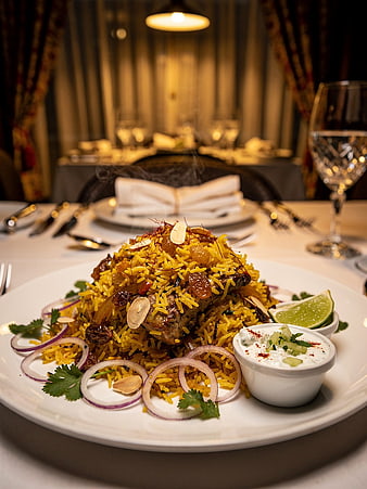 Steaming Chicken Biryani with Raita on Elegant Dining Table