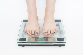 Bare feet standing on a digital bathroom scale
